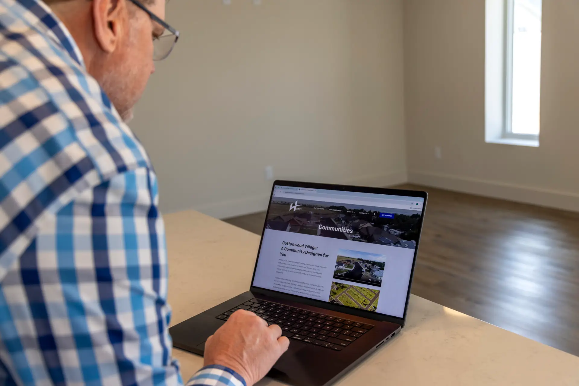 Chad of Harvell Homes, a client of CROFT, viewing his website on a MacBook